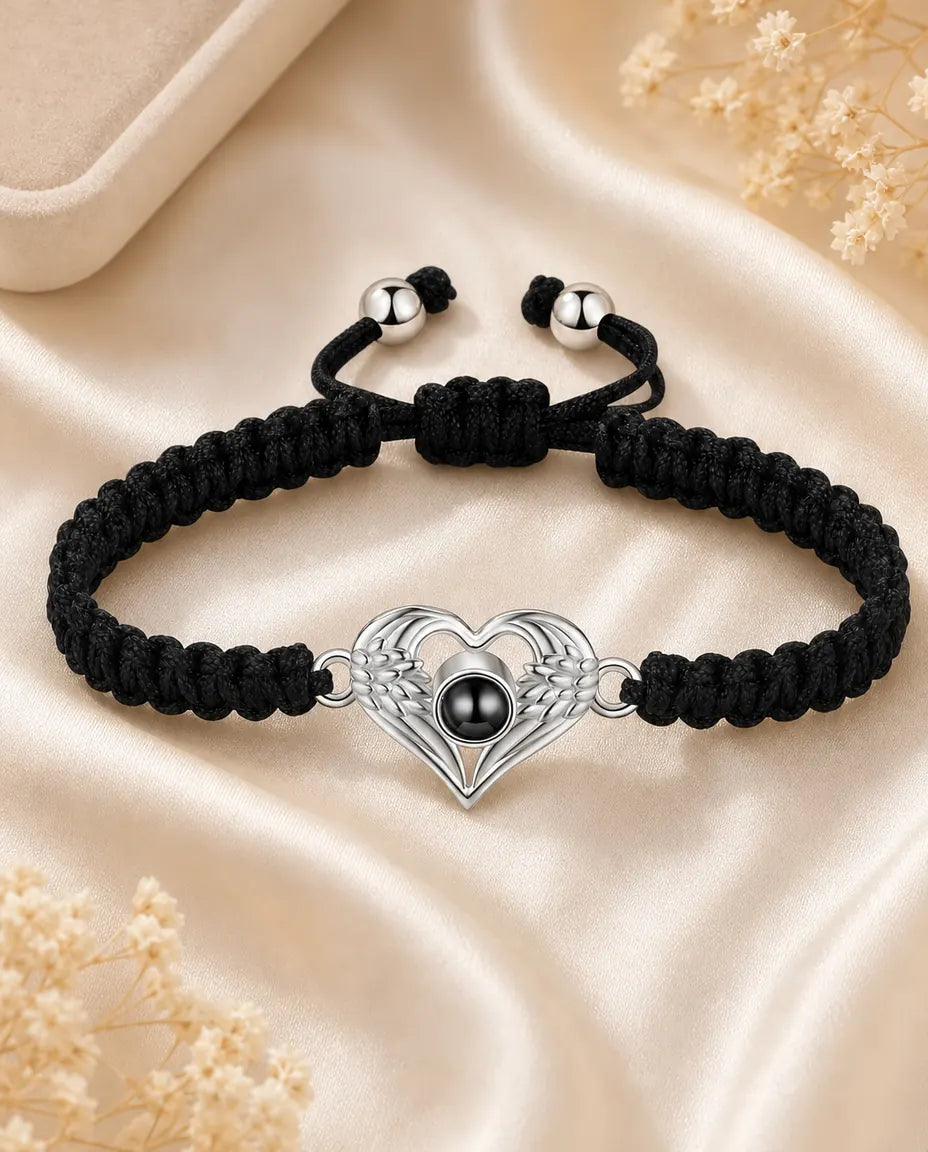 Angel wing heart photo projection bracelet with black braided cord on cream silk