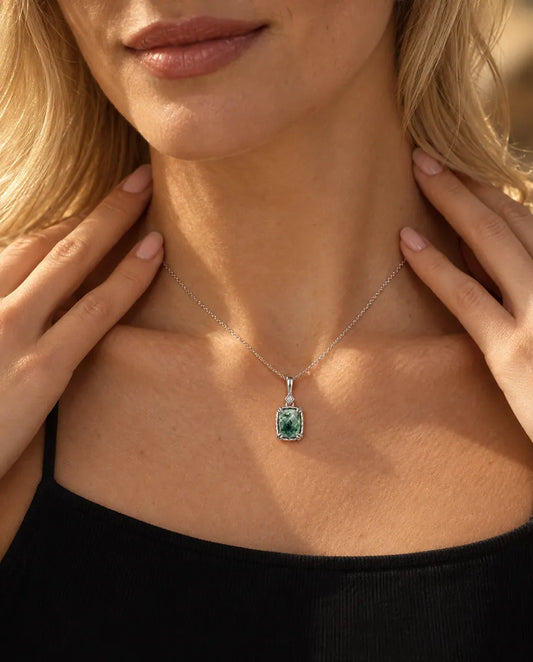 Moss Agate Pendant Necklace in 925 Sterling Silver - worn on a model with her hand at her neck