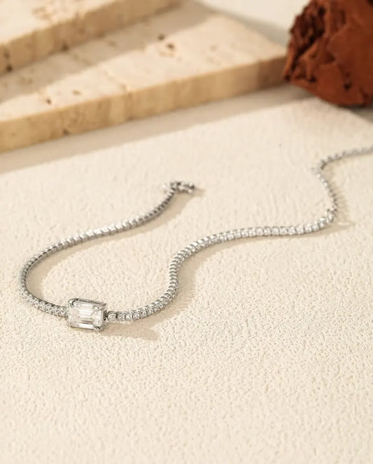emerald cut moissanite tennis bracelet in 925 sterling silver on a wrist
