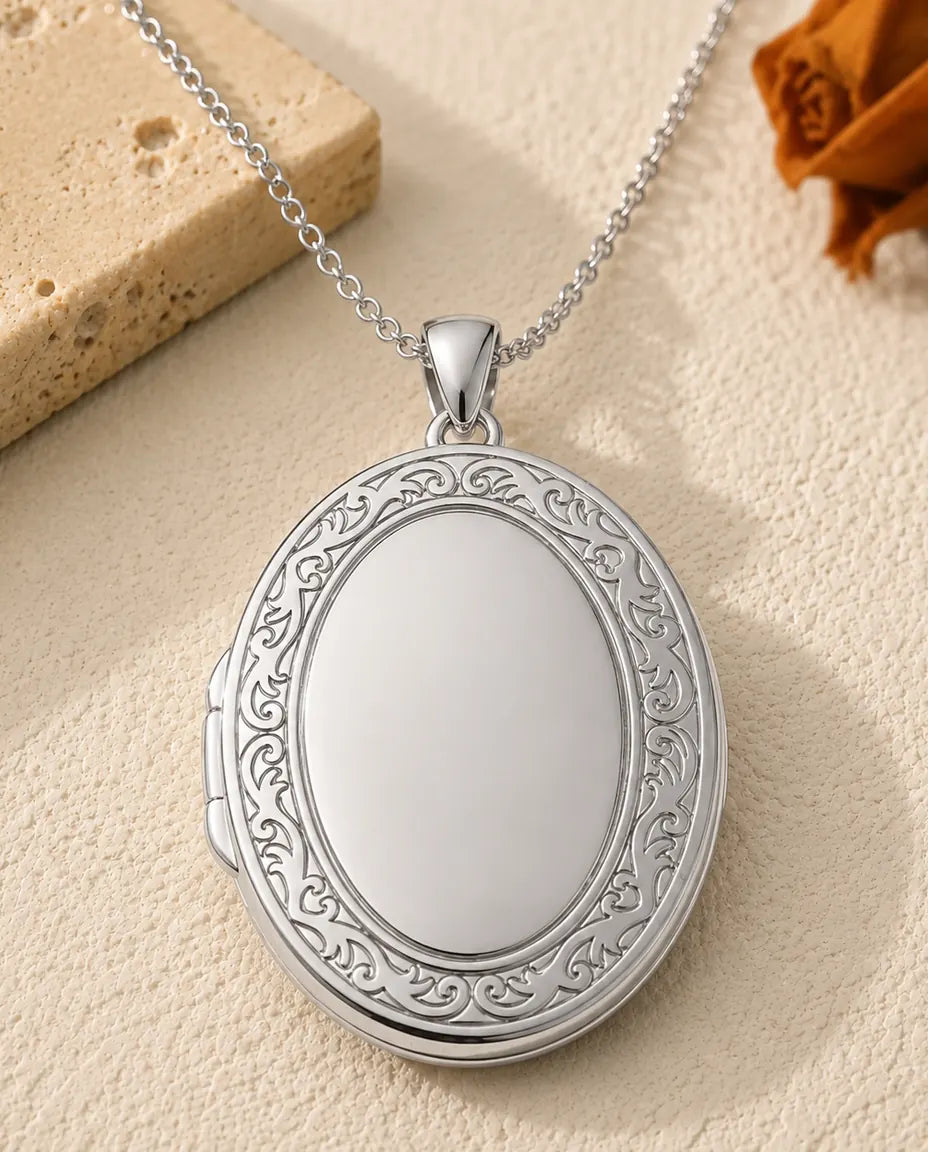 Engravable oval photo locket necklace in silver, front view
