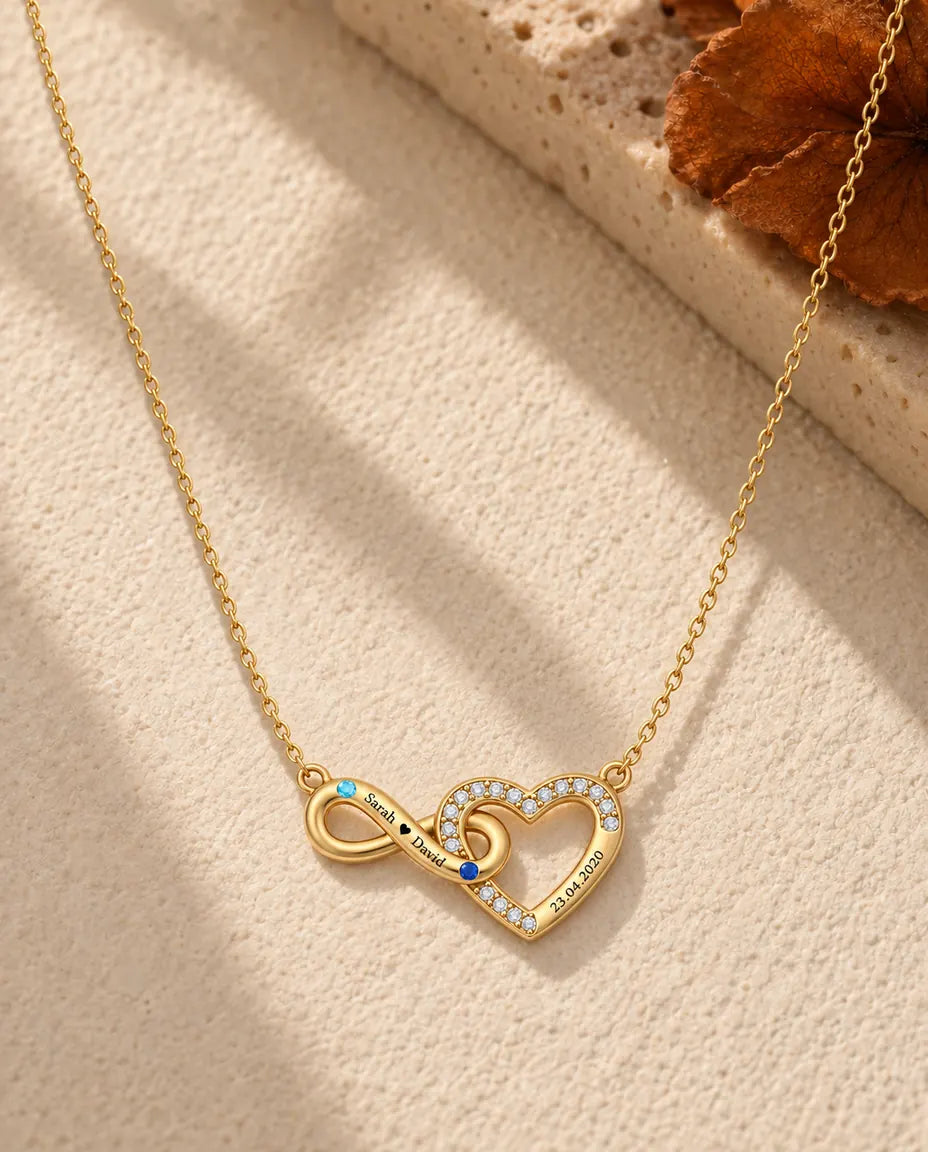 Gold infinity heart necklace engraved with two names and a date