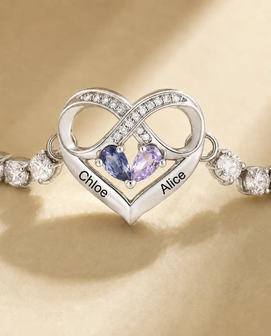 Close-up of the infinity heart charm with two pear birthstones and two engraved names