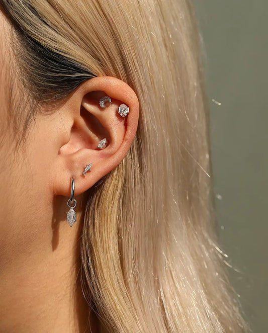 Shark Stud Earrings in 925 Sterling Silver with Moissanite - worn on a model, wider view of ear and neck