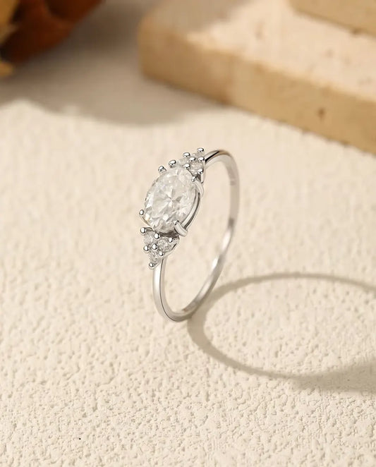 1 carat oval moissanite engagement ring in 925 sterling silver with zirconia side clusters