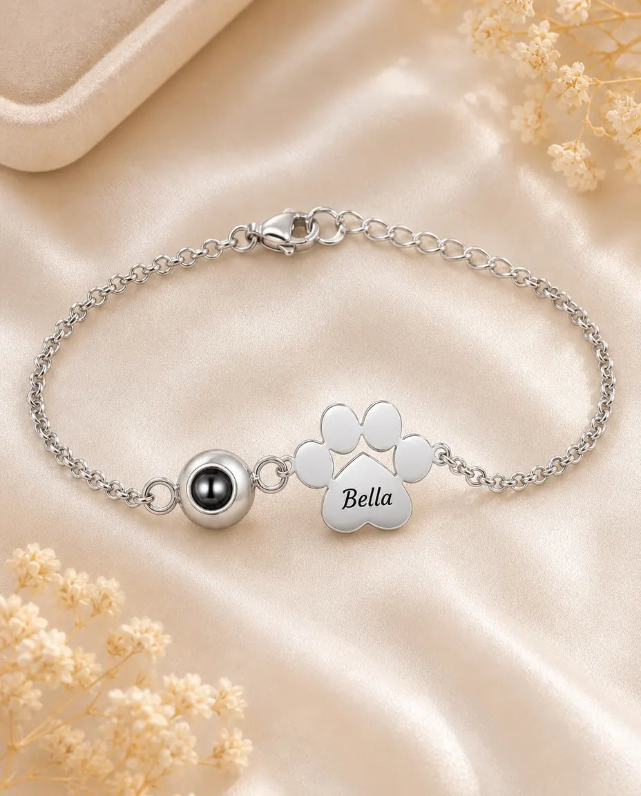 Personalised pet photo projection bracelet in silver with engraved paw print charm on cream silk