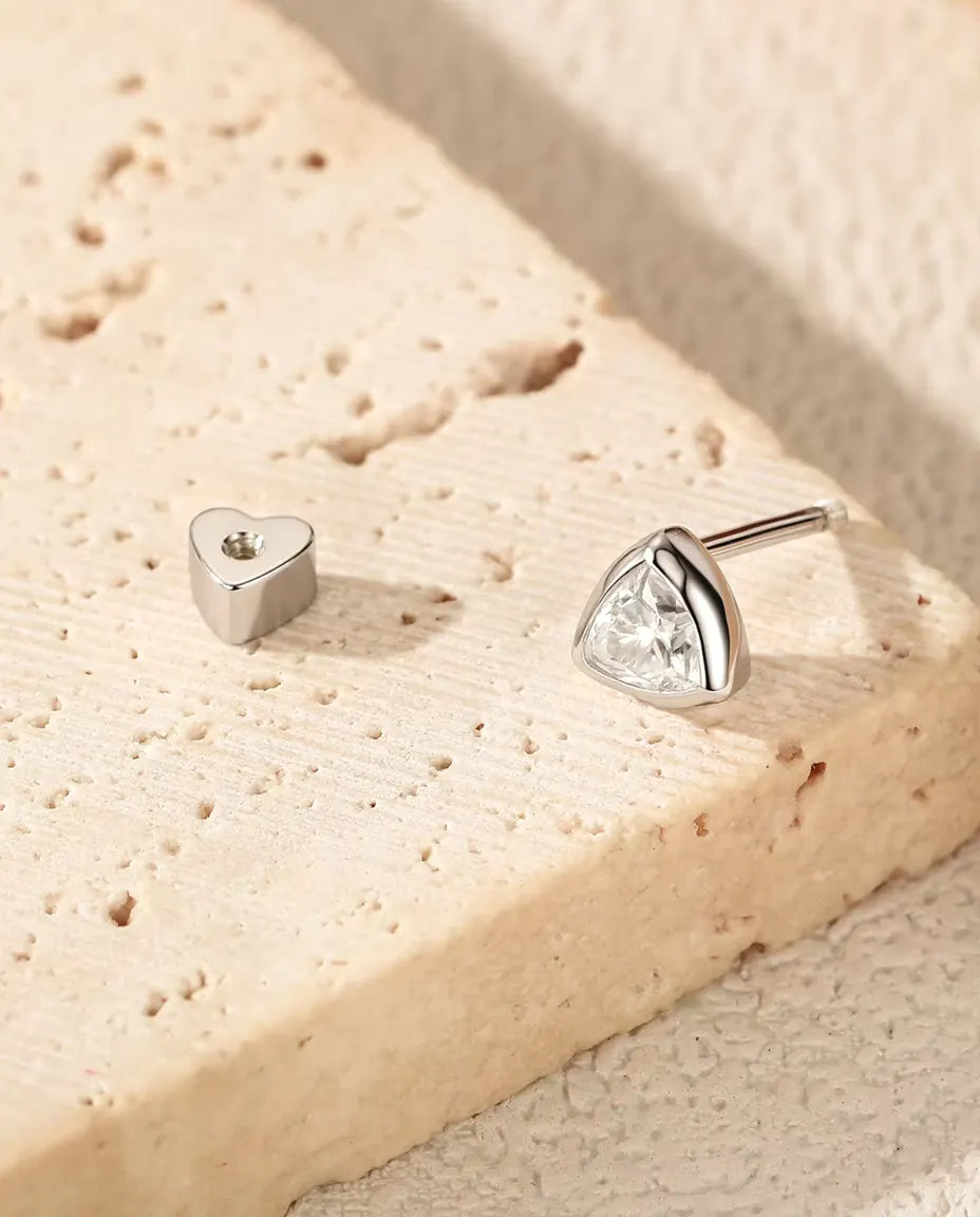 Trillion Moissanite Bezel Stud Earrings in 925 Sterling Silver - with the heart-shaped back taken off and set beside it