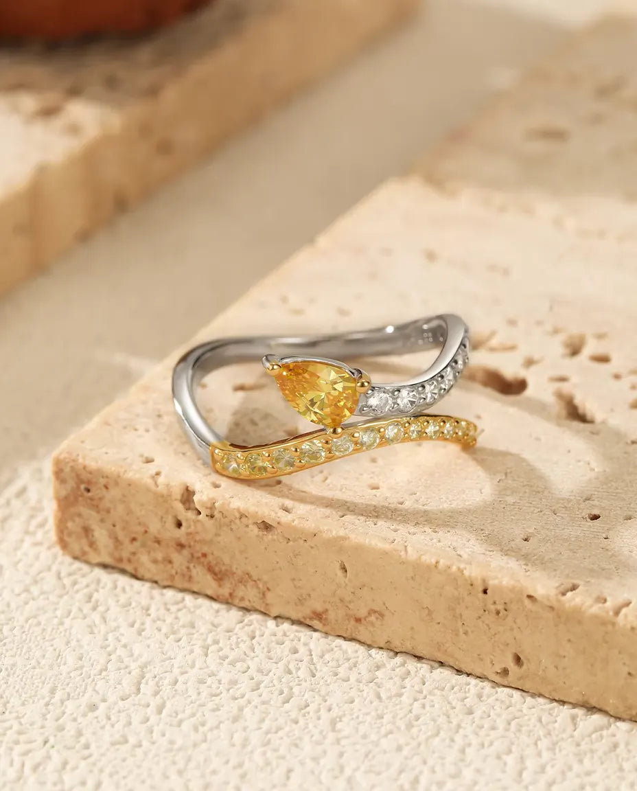 Yellow pear cut bypass ring in 925 sterling silver with two tone pave bands