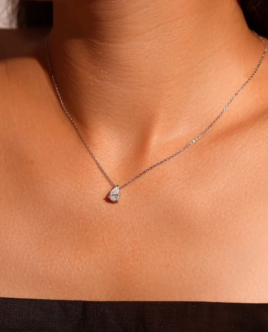 1 ct Pear Moissanite Necklace in 925 Sterling Silver - worn on a model, close-up at the collarbone