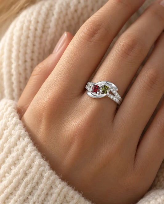 Sterling silver 2 name birthstone ring with two engraved names worn on a model's ring finger