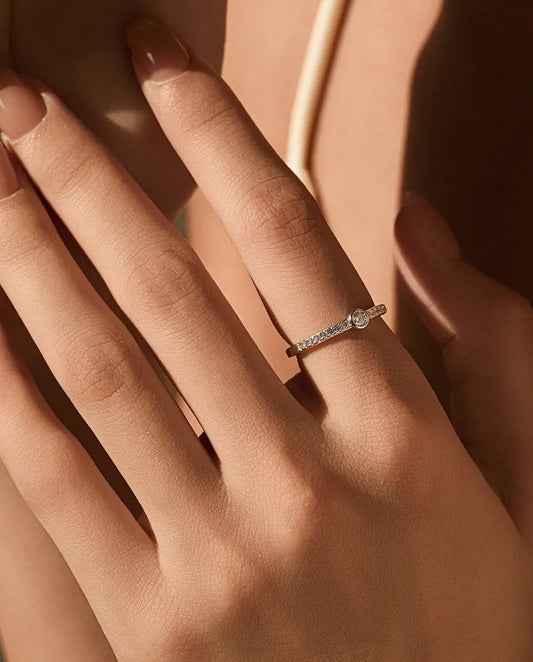 Bezel-set moissanite solitaire ring in 925 sterling silver with pave shoulders