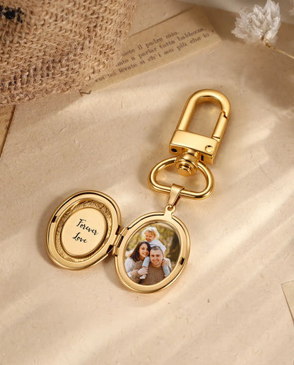 Gold oval locket keyring on vintage paper with dried flowers