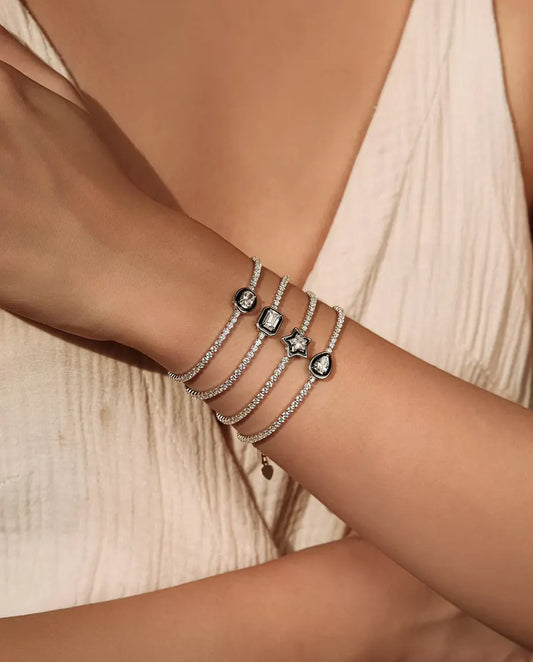 Tennis Bracelet in 925 Sterling Silver with a Black Framed Cubic Zirconia Charm - four shapes stacked on a wrist