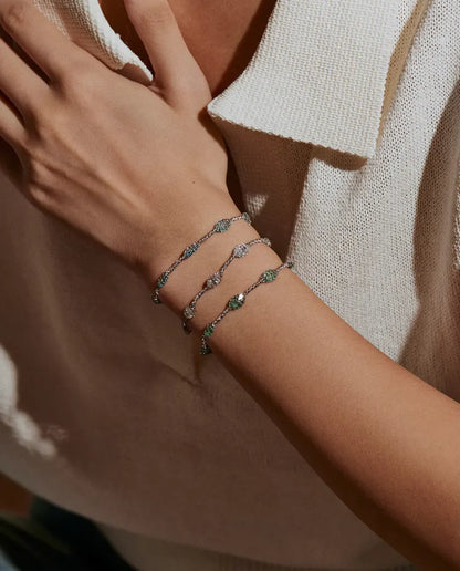 Caged Zircon Bracelet in 925 Sterling Silver - worn on a wrist, hand resting at the collar