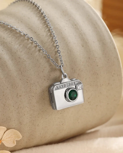Silver camera photo locket necklace with a green birthstone lens