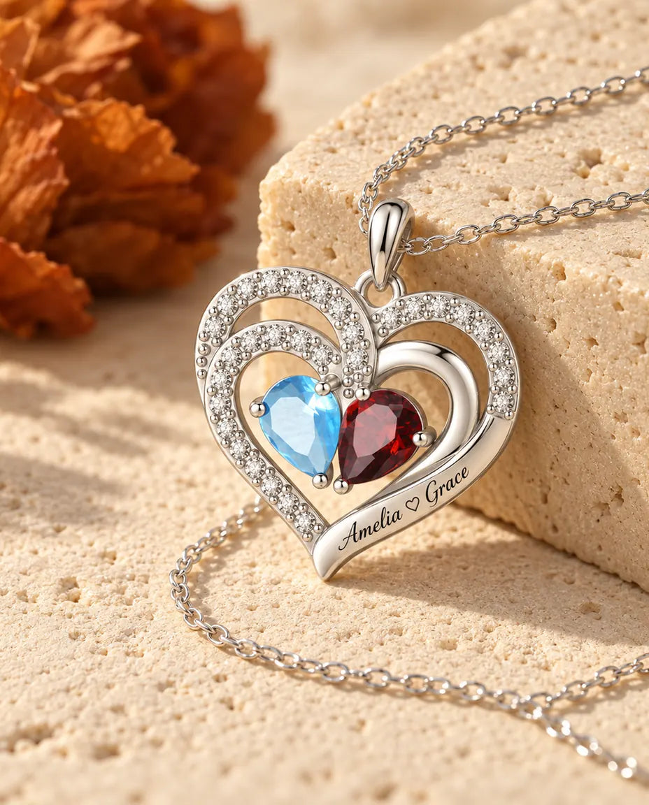 Double heart birthstone necklace photographed from a low angle