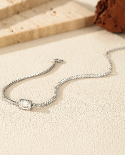 Tennis bracelet with a 1ct D colour emerald cut moissanite centre stone and cubic zirconia side stones, 925 sterling silver