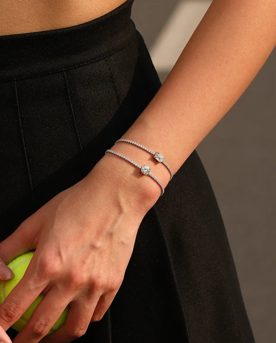 Tennis bracelet with a 1ct D colour emerald cut moissanite centre stone and cubic zirconia side stones, 925 sterling silver