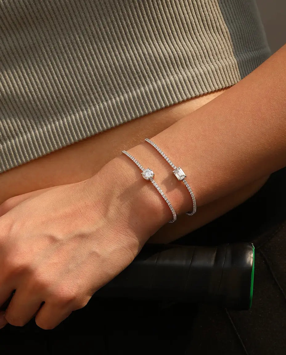 Tennis bracelet with a 1ct D colour emerald cut moissanite centre stone and cubic zirconia side stones, 925 sterling silver