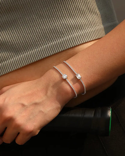 Tennis bracelet with a 1ct D colour emerald cut moissanite centre stone and cubic zirconia side stones, 925 sterling silver