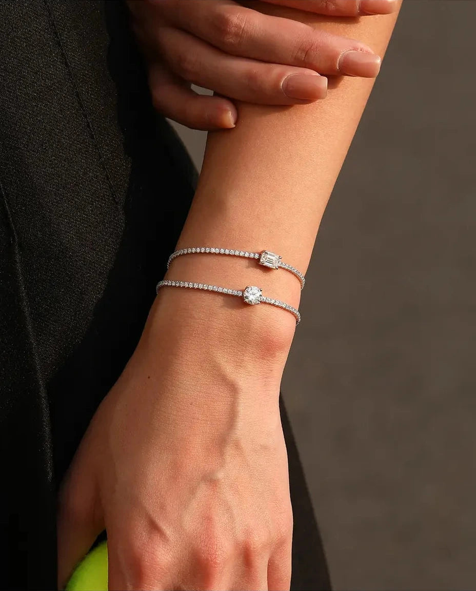 Tennis bracelet with a 1ct D colour emerald cut moissanite centre stone and cubic zirconia side stones, 925 sterling silver
