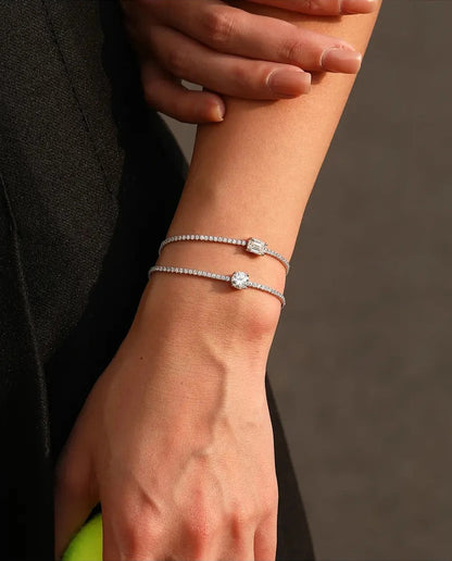 Tennis bracelet with a 1ct D colour emerald cut moissanite centre stone and cubic zirconia side stones, 925 sterling silver