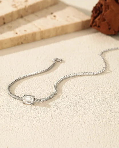 Tennis bracelet with a 1ct D colour emerald cut moissanite centre stone and cubic zirconia side stones, 925 sterling silver