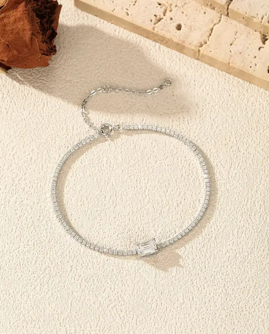 emerald cut moissanite tennis bracelet in 925 sterling silver on a wrist