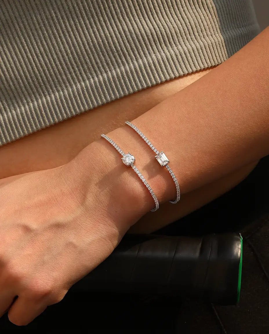 emerald cut moissanite tennis bracelet in 925 sterling silver on a wrist