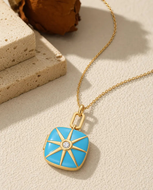 Turquoise enamel photo locket necklace with a gold starburst and crystal centre
