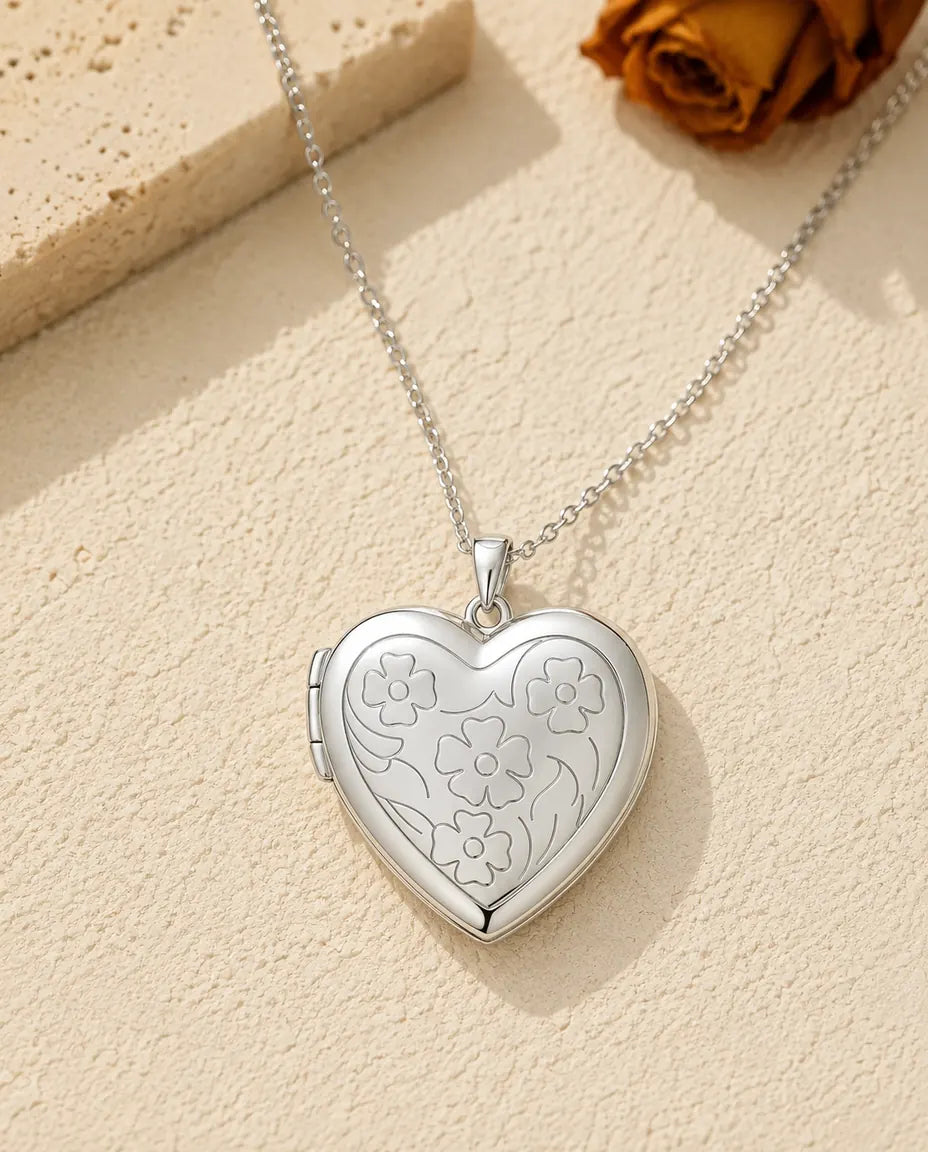 Floral carved heart photo locket necklace in silver, front view