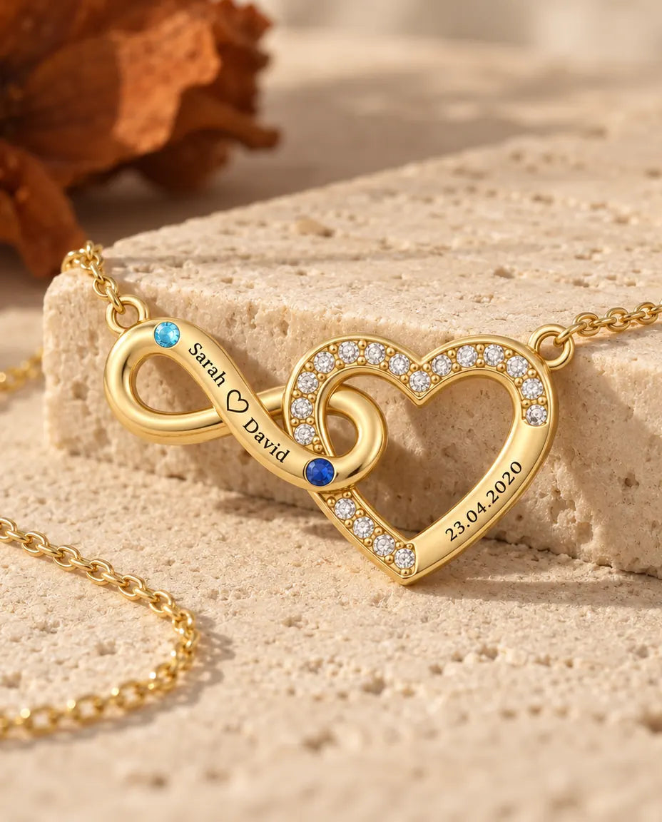 Gold infinity heart necklace photographed from a low angle