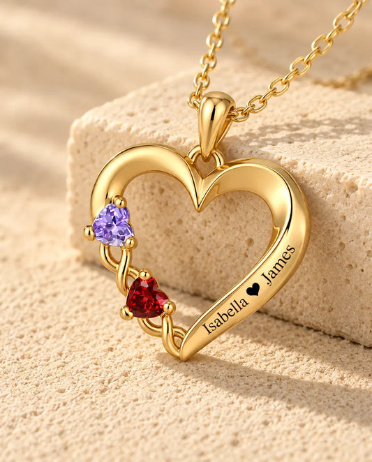 Close-up of the gold open heart pendant with two heart birthstones on a vine setting