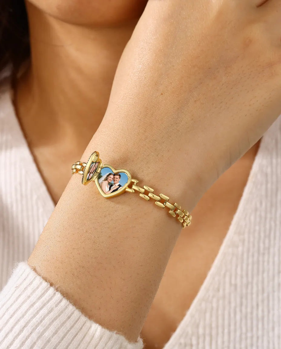 Model wearing gold heart locket bracelet open with two photos