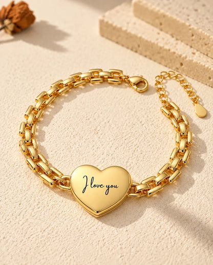 Back of the gold-tone heart locket bracelet engraved “I love you” in script