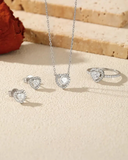Heart Moissanite Jewellery Set in 925 Sterling Silver - the full set on a cream stone surface