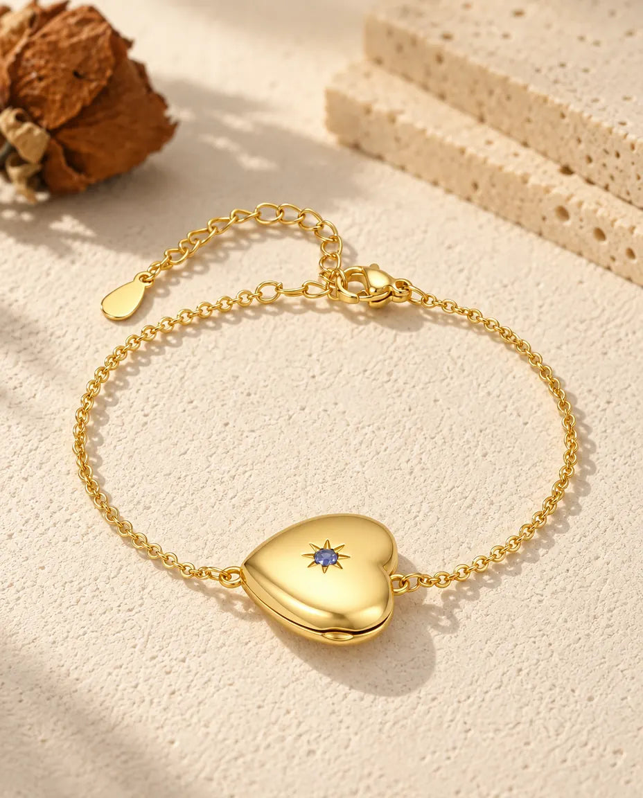 Personalised gold-tone heart photo locket bracelet with a birthstone set in a star on the front