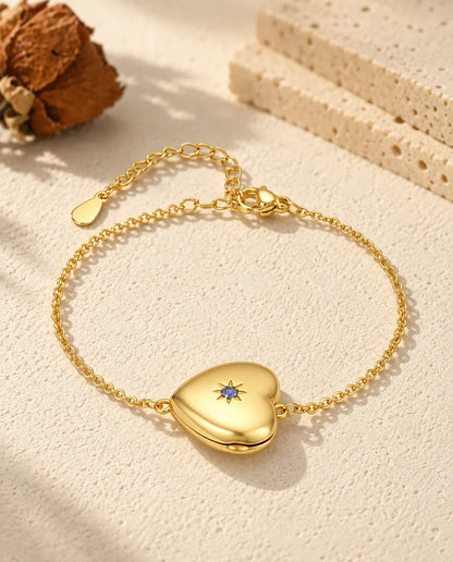 Personalised gold-tone heart photo locket bracelet with a birthstone set in a star on the front