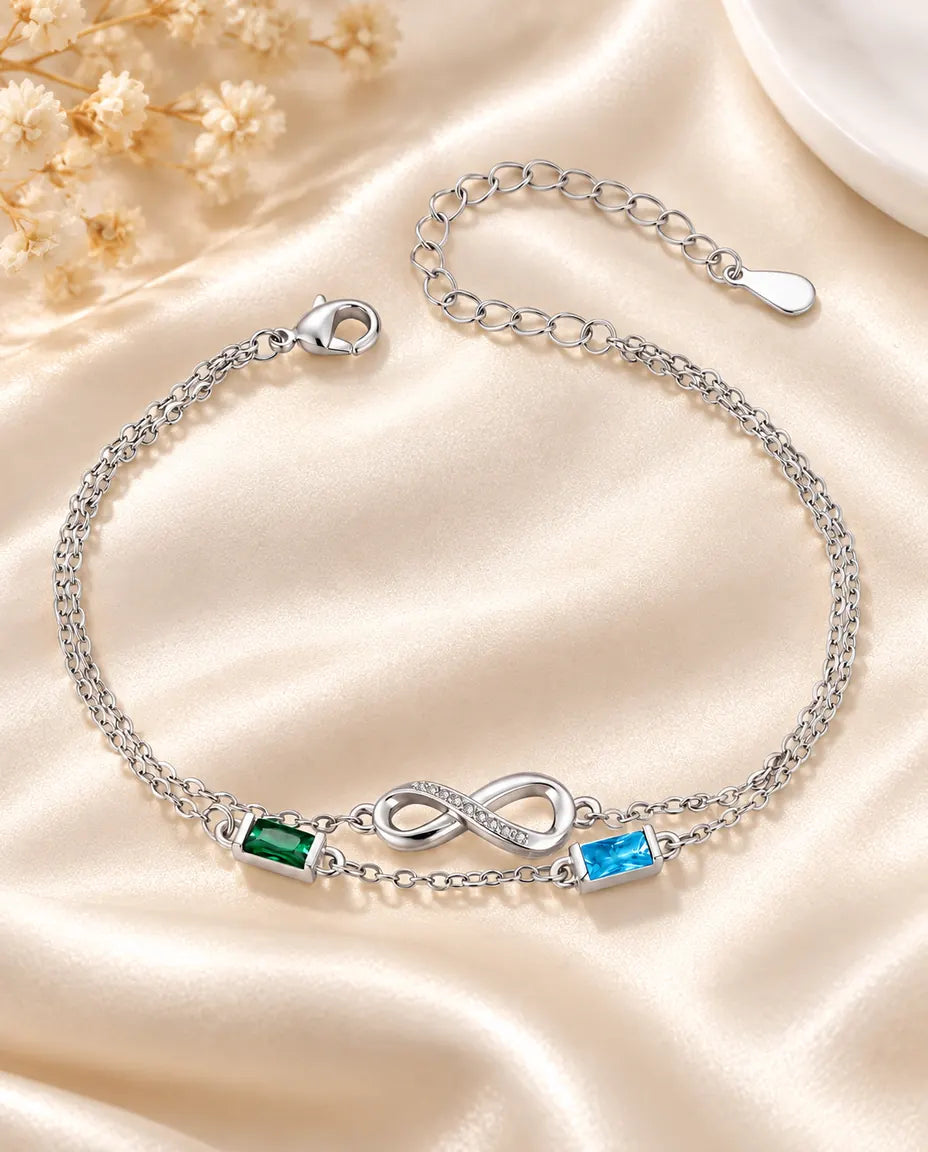 Personalised infinity birthstone bracelet with two baguette birthstones on a double silver chain