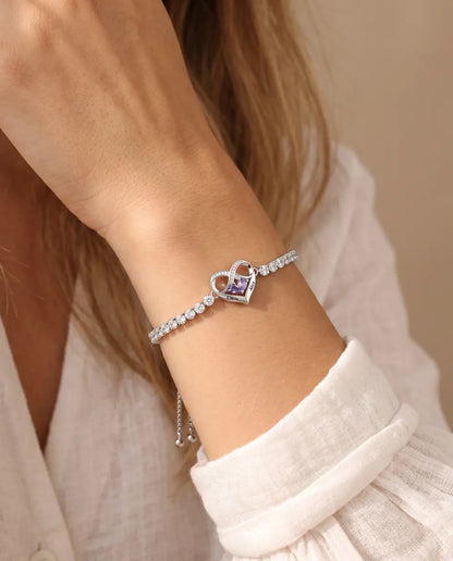 Adjustable tennis bracelet with infinity heart charm on a model