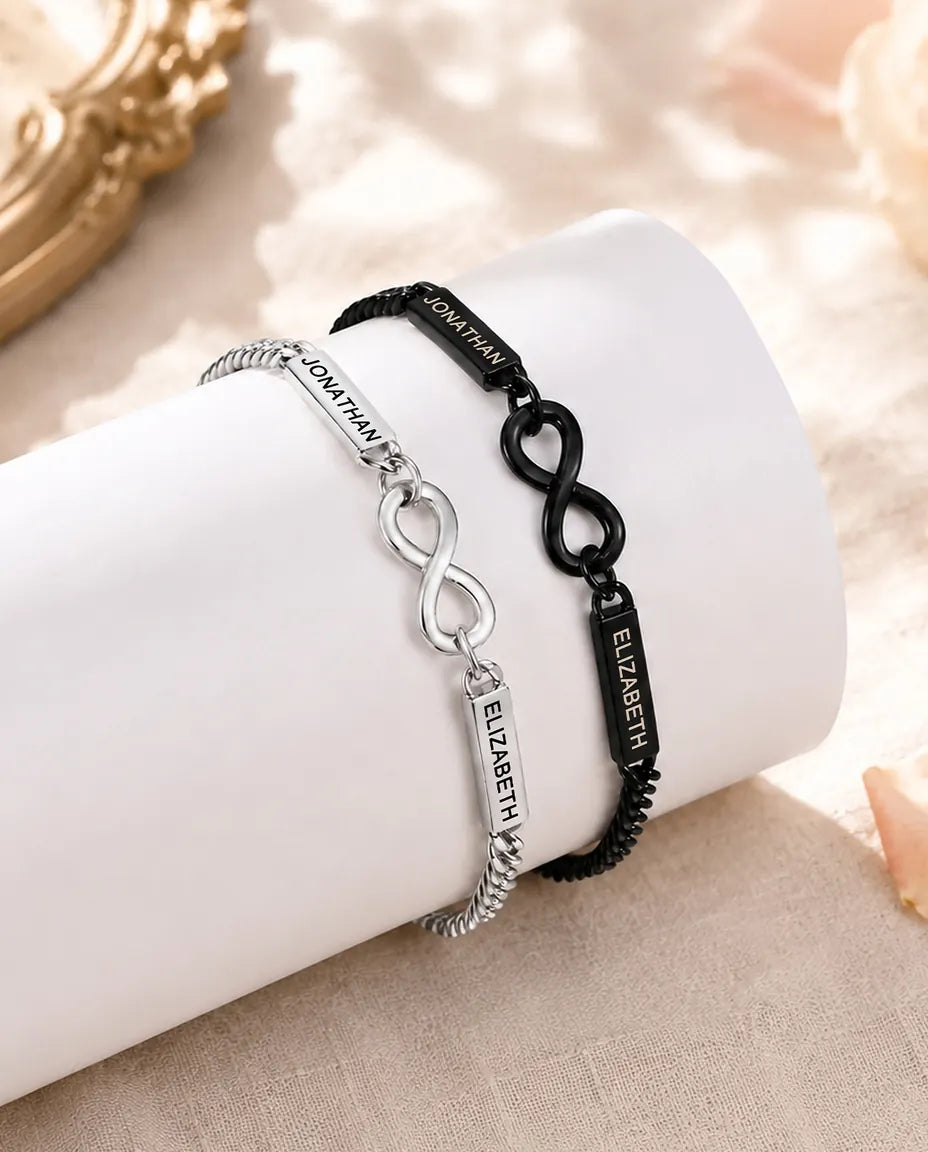 Personalised Infinity Couple Bracelets With 2 Engraved Names - Matching Silver & Black Name Bar Bracelet Set - matching pair styled on a display stand