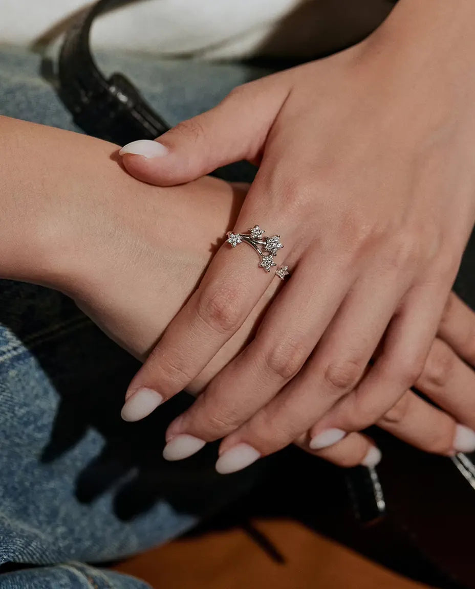 Moissanite Star Cluster Ring in 925 Sterling Silver - worn on a model’s hand resting on denim