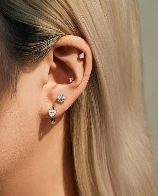 Three-Stone Moissanite Trefoil Stud Earrings in 925 Sterling Silver - worn in the ear, close-up