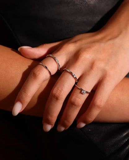 Moissanite Wave Ring in 925 Sterling Silver - worn on a model with hands crossed