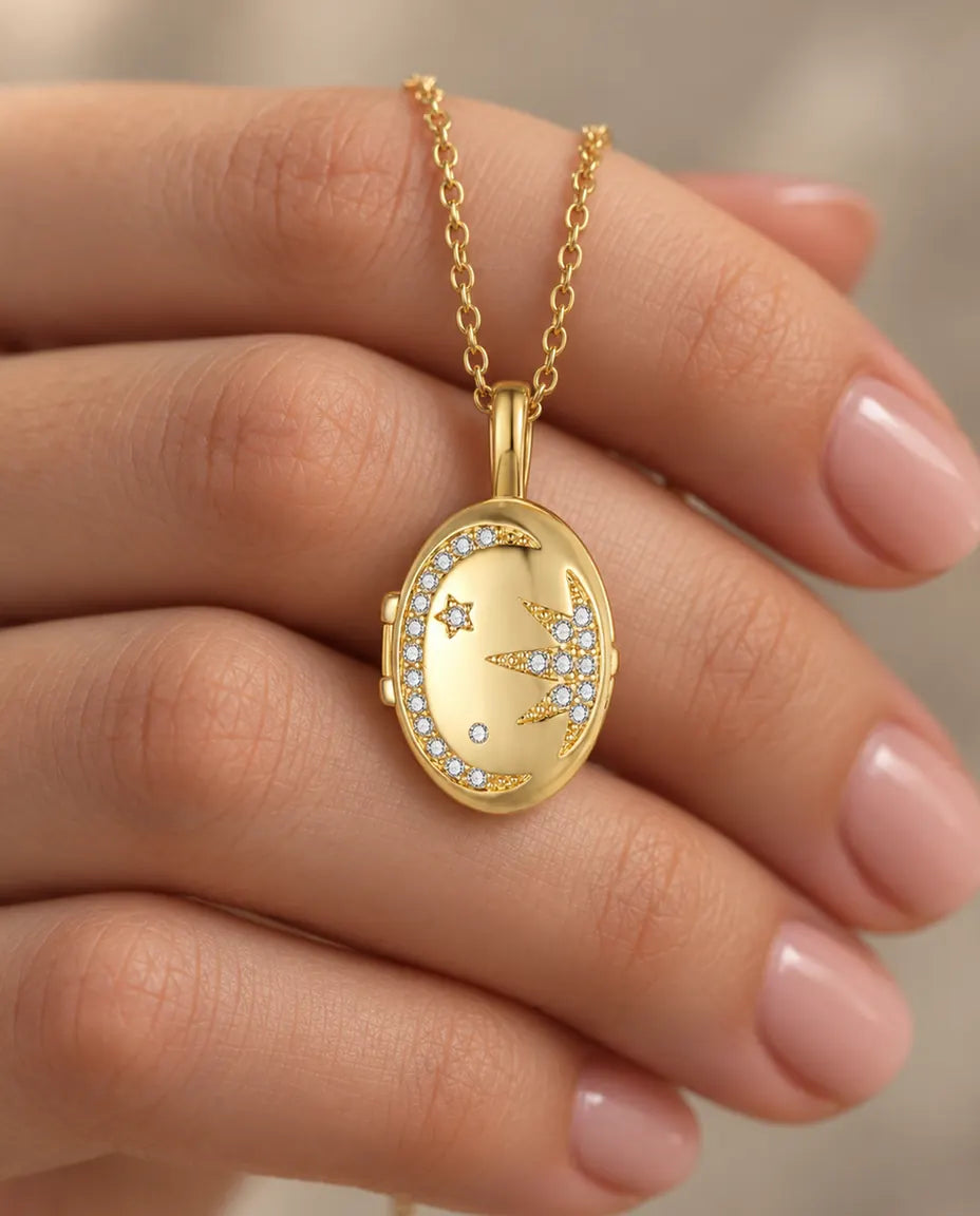 Personalised Moon & Star Oval Photo Locket Necklace That Holds 2 Pictures held in hand