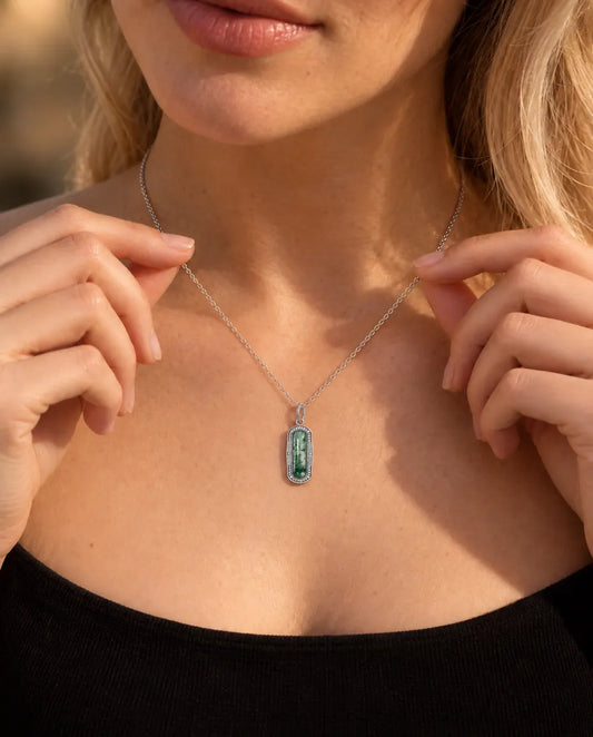 Moss Agate Bar Necklace in 925 Sterling Silver - worn on a model holding the chain with her fingertips