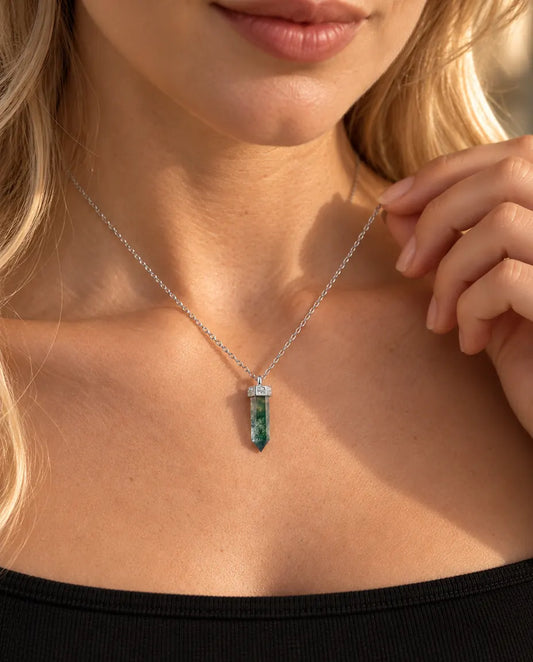 Moss Agate Point Necklace in 925 Sterling Silver - worn on a model holding the chain with her fingertips