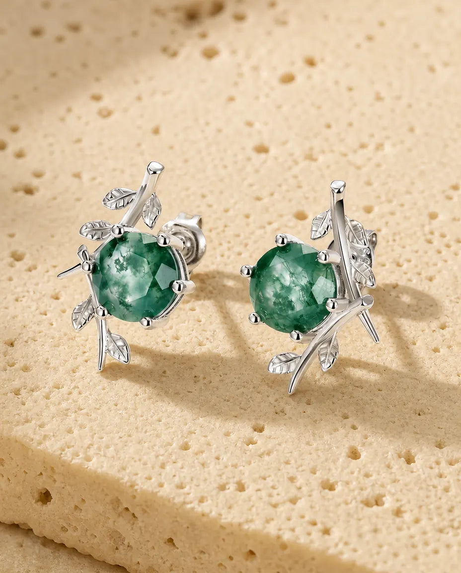 Round moss agate stud earrings with a leafy silver twig