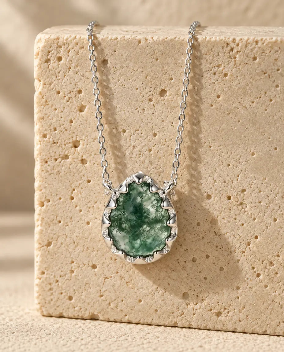 Moss Agate Necklace - displayed on a travertine block