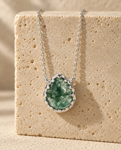 Moss Agate Necklace - displayed on a travertine block