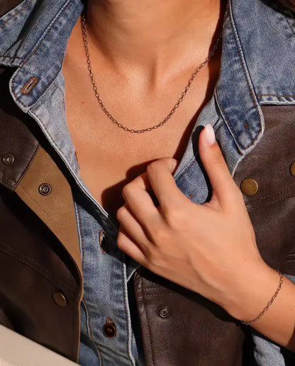 Oval Link Chain Necklace in 925 Sterling Silver - worn on a model, hand holding the jacket collar